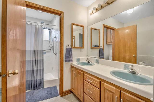 887 Village Way Alpine, UT 84004 - Photo 22 of 28 Bathroom with double vanity, a shower stall, and light tile patterned floors