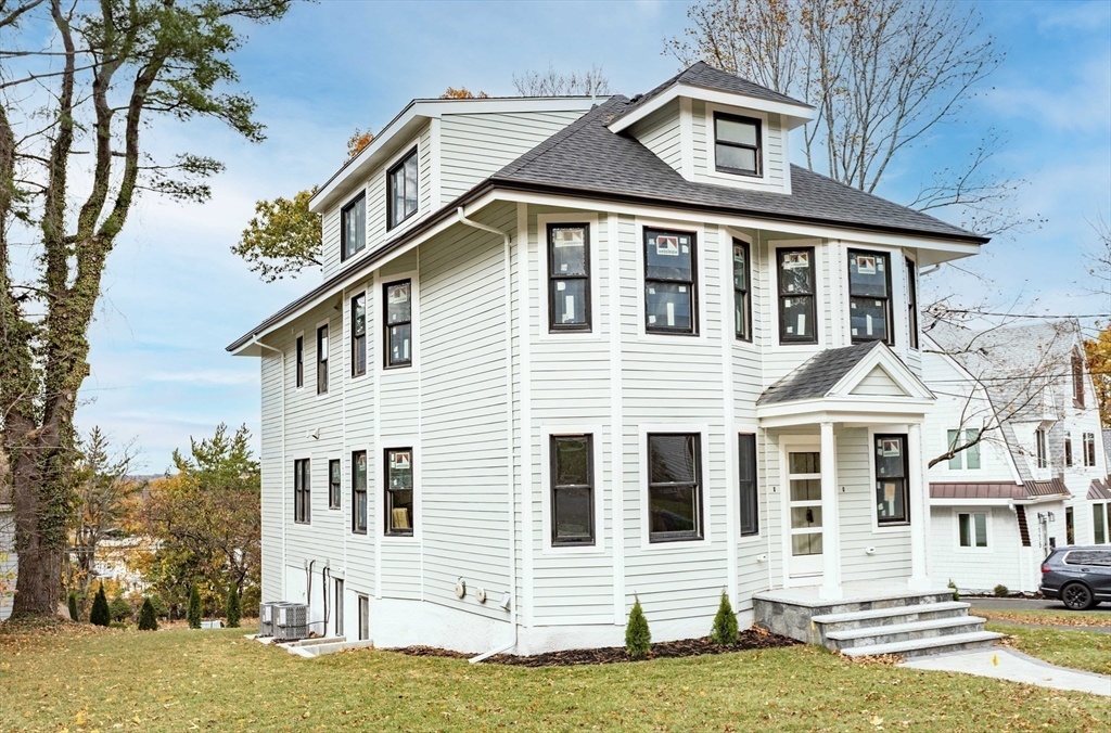125 Mt Vernon Street, Unit 2 Newton, MA 02465 - Photo 1 of 36 a front view of a house with a yard