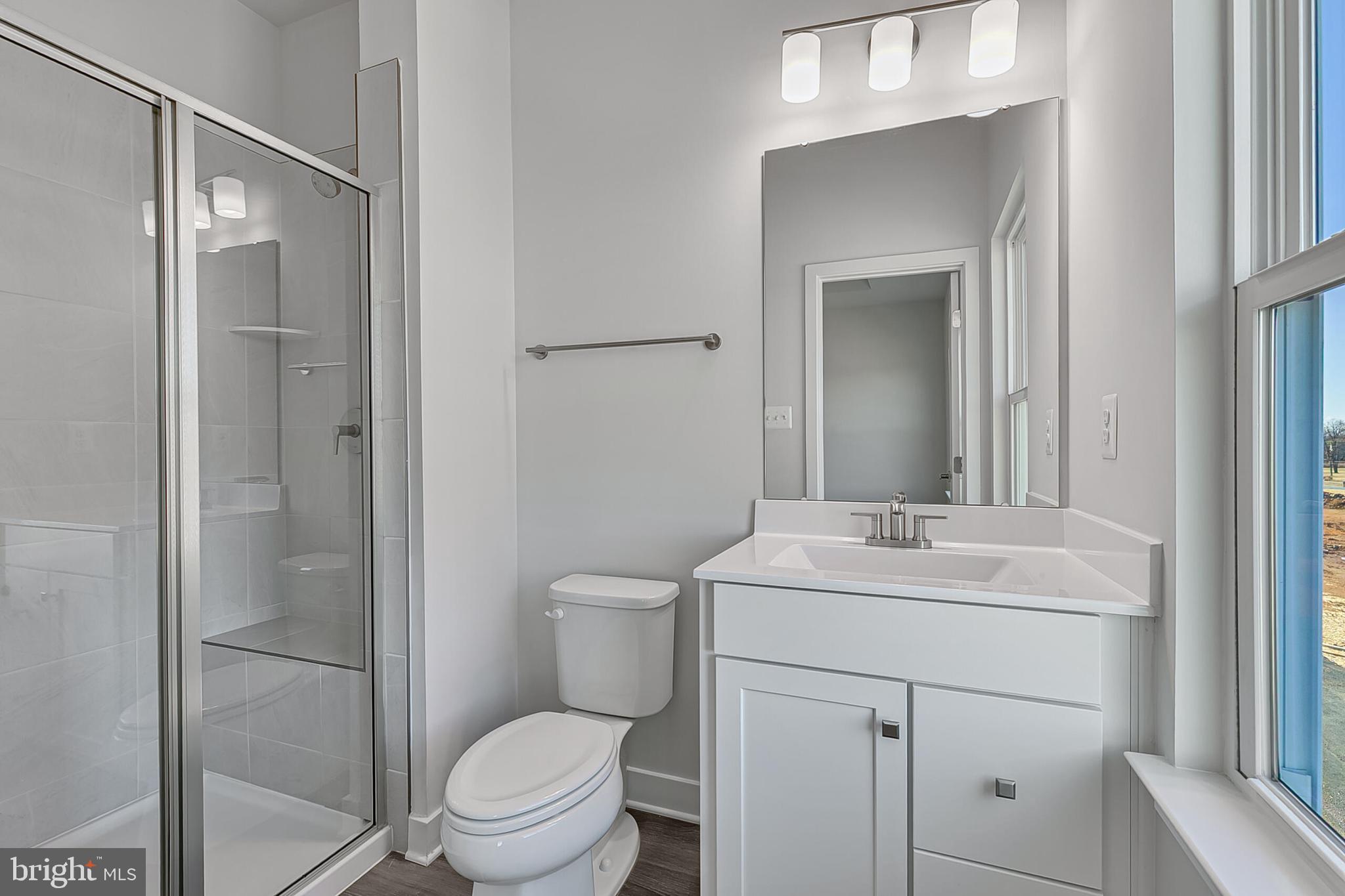 33 B Oasis Avenue Ranson, WV 25438 - Photo 35 of 38 a bathroom with a toilet sink vanity and mirror