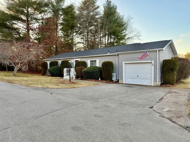 a view of a house with a yard and garage