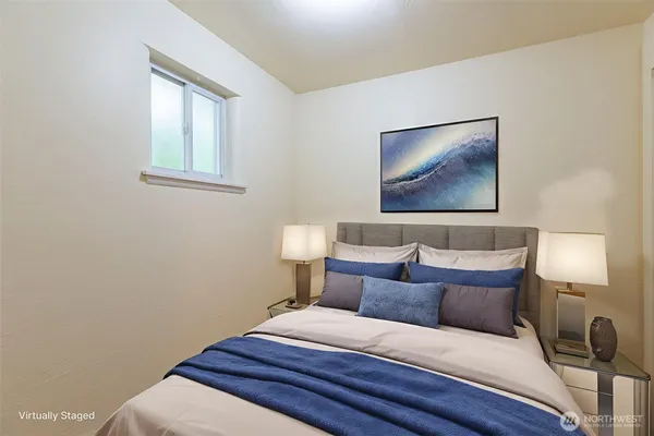 a bedroom with a bed and a lamp