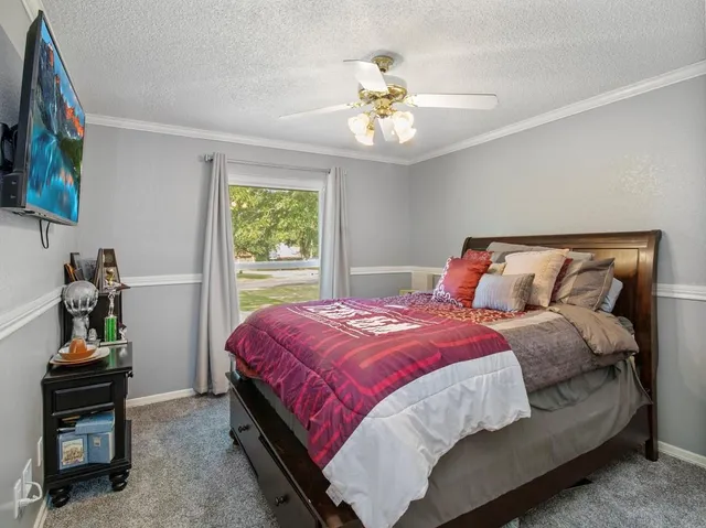 a view of a backyard with table and chairs under an umbrella