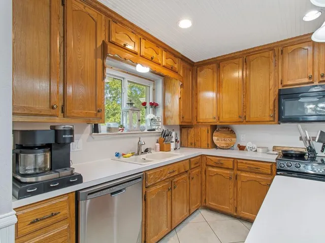 a kitchen with a sink a stove and cabinets