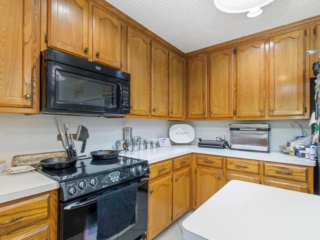 a kitchen with a sink a stove and refrigerator