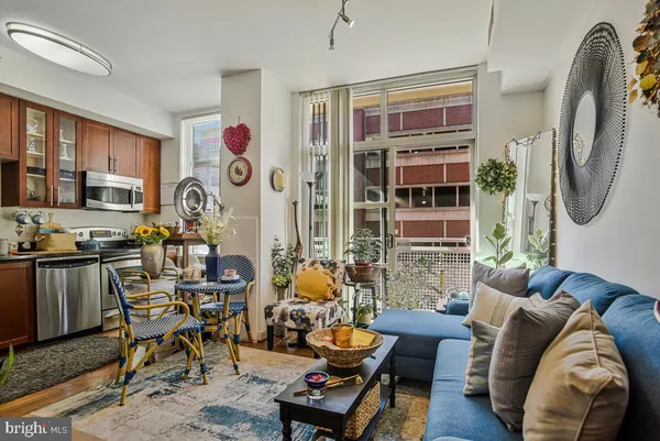 a living room with patio furniture and a fireplace