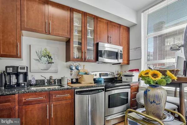 a kitchen with a sink cabinets and window