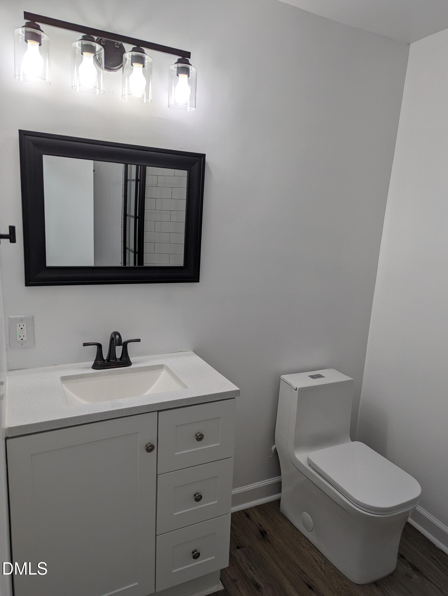 4816 Whitehall Avenue Raleigh, NC 27604 - Photo 11 of 23 a bathroom with a toilet sink and mirror