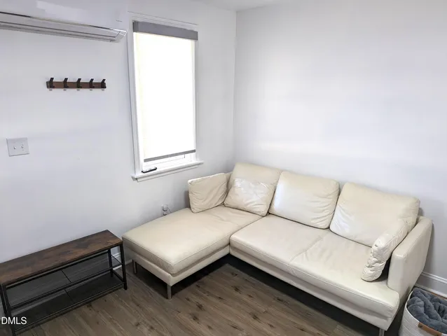 a living room with a couch and a window