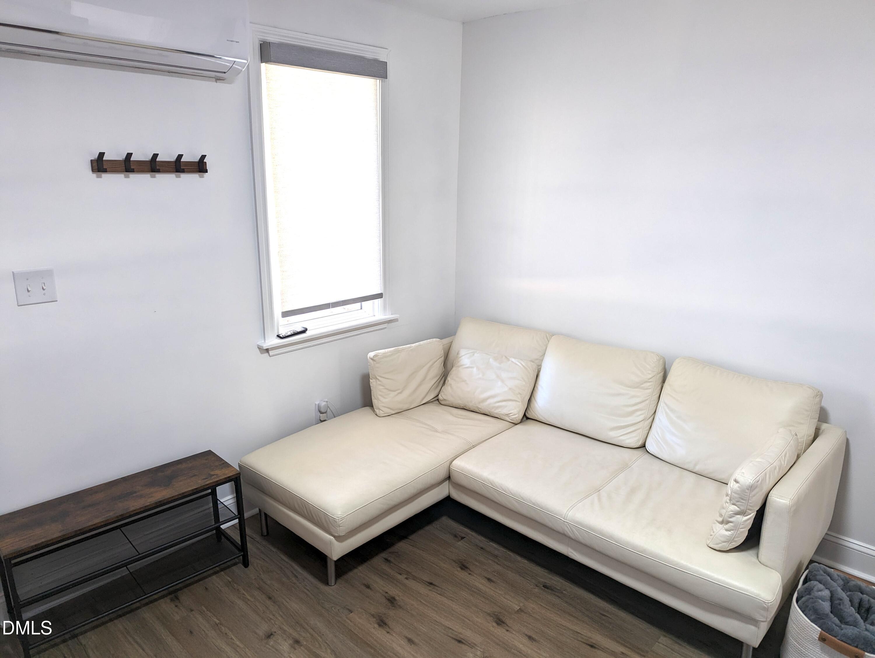 4816 Whitehall Avenue Raleigh, NC 27604 - Photo 12 of 23 a living room with a couch and a window