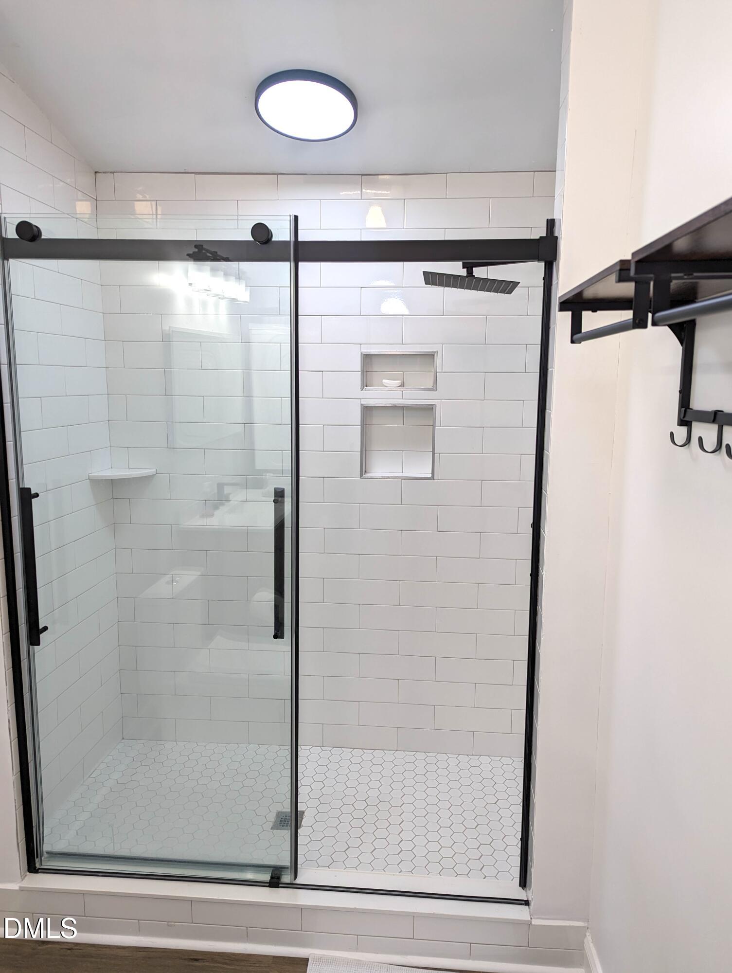 4816 Whitehall Avenue Raleigh, NC 27604 - Photo 16 of 23 a bathroom with a glass shower door