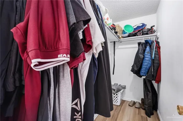 a view of walk in closet with clothes