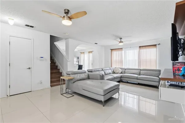 a living room with furniture and a chandelier