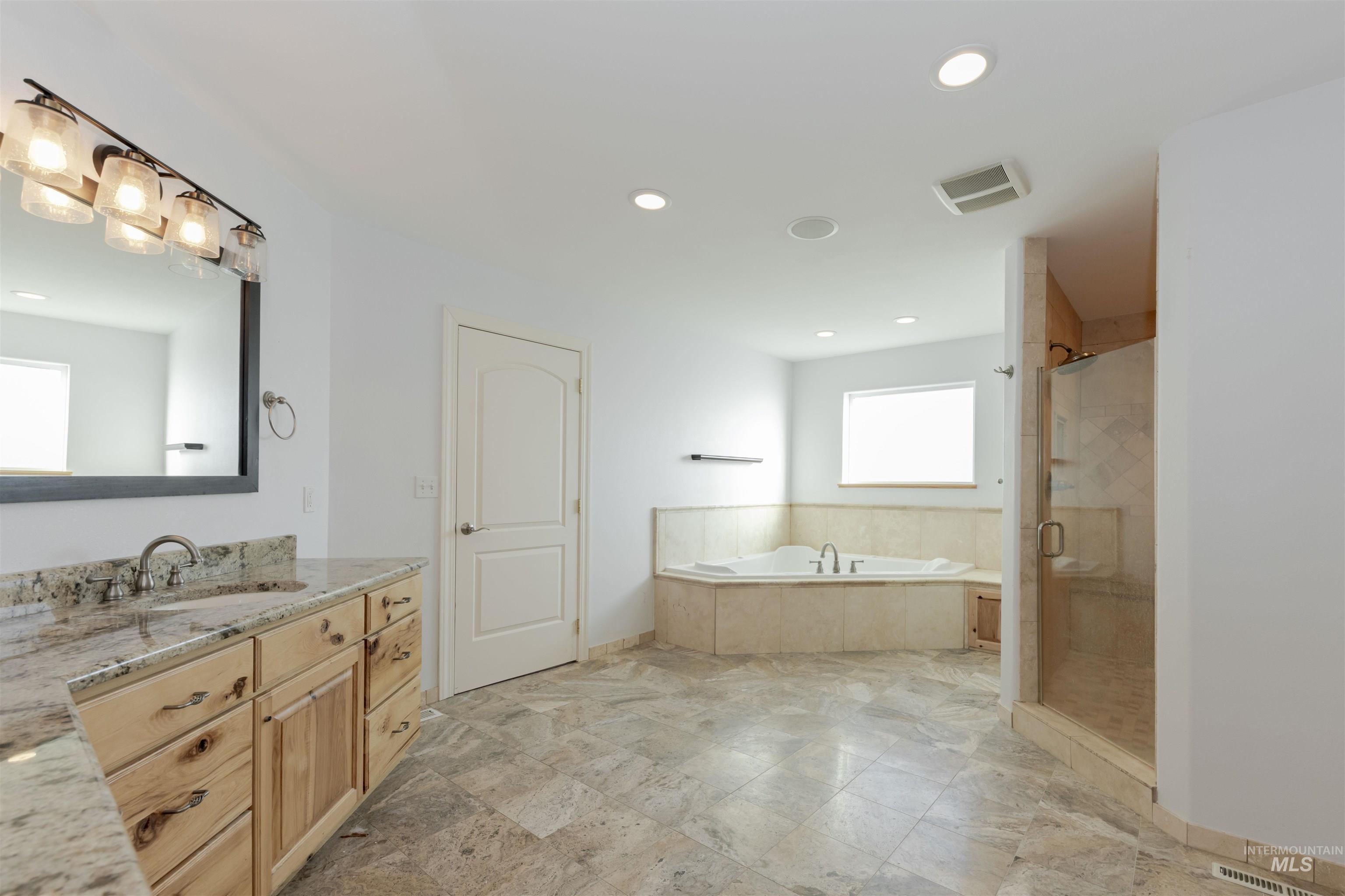 7591 Pheasant Chase Drive Lewiston, ID 83501 - Photo 22 of 32 Bathroom featuring a garden tub, a stall shower, vanity, and recessed lighting
