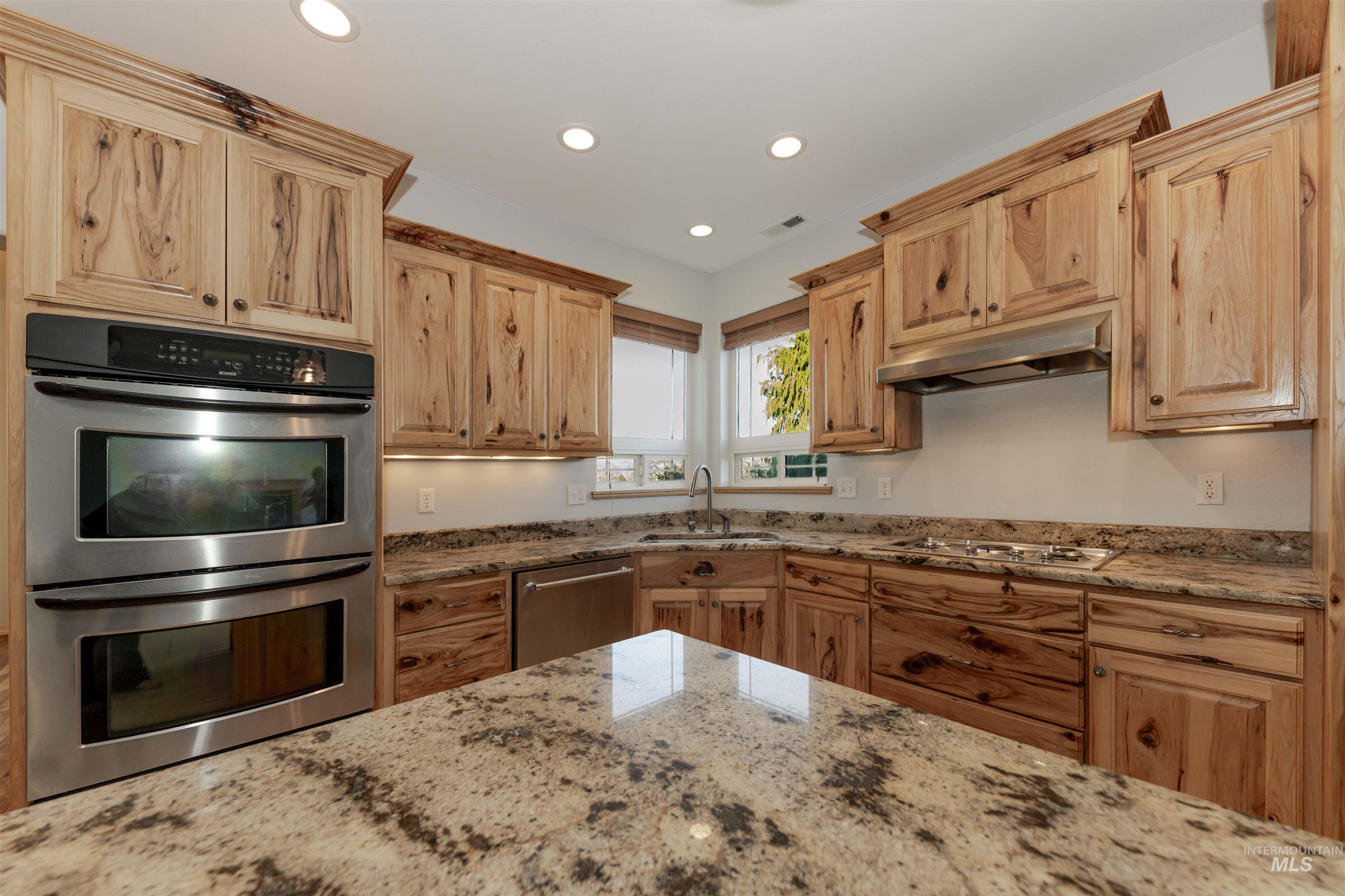 7591 Pheasant Chase Drive Lewiston, ID 83501 - Photo 7 of 32 Kitchen featuring appliances with stainless steel finishes, recessed lighting, light stone counters, and under cabinet range hood
