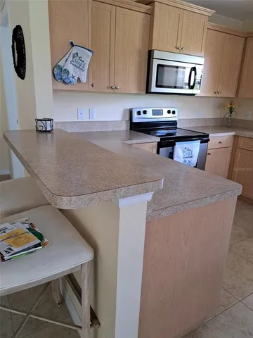 a kitchen with stainless steel appliances a stove a sink and a refrigerator