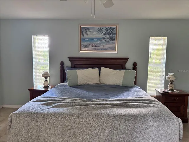 a bedroom with bed and painting on the wall