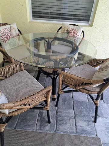 a living room with chairs and a table