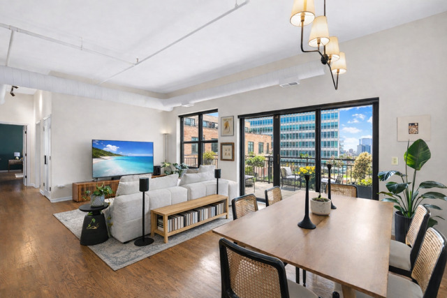 520 West Huron Street, Unit 705 Chicago, IL 60654 - Photo 5 of 14 a living room with furniture and large windows