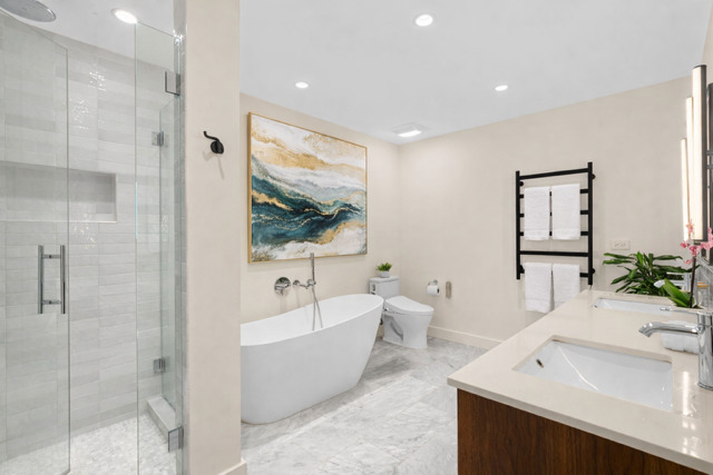 520 West Huron Street, Unit 705 Chicago, IL 60654 - Photo 8 of 14 a bathroom with a bathtub a sink and a large mirror