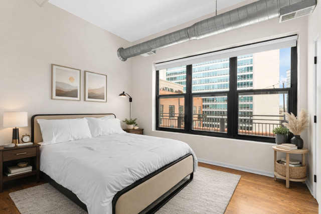 520 West Huron Street, Unit 705 Chicago, IL 60654 - Photo 10 of 14 a spacious bedroom with a large bed and a large window
