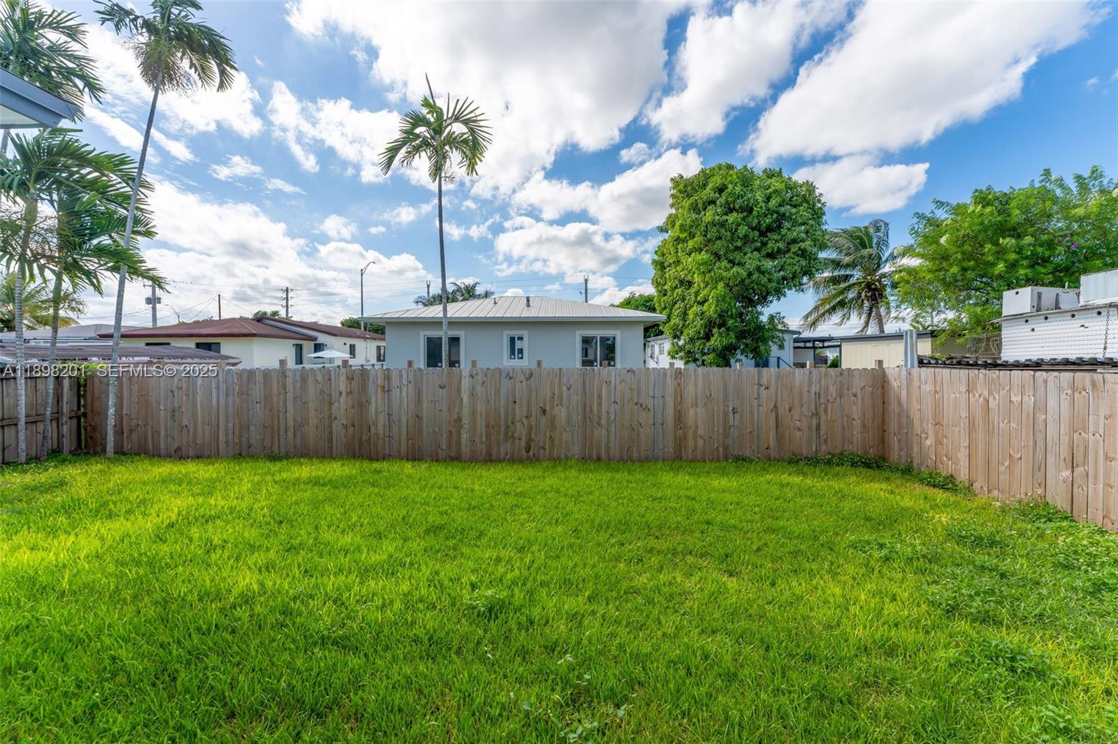 3840 Southwest 91 Avenue Miami, FL 33165 - Photo 20 of 24 a view of a yard with wooden fence