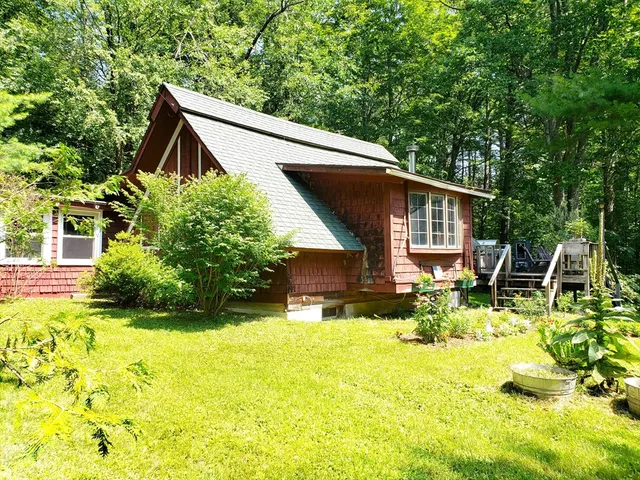 a house view with swimming pool and garden space