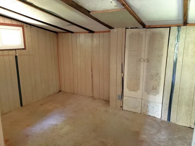 a bed sitting in a bedroom next to a window