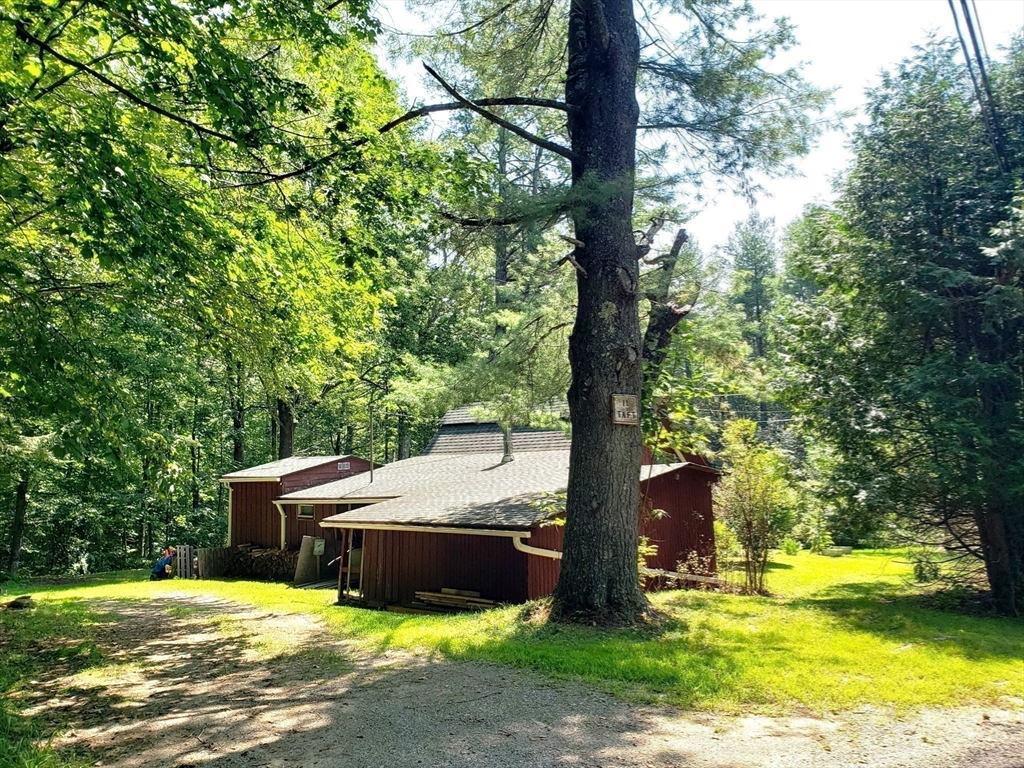 11 Taft Road Chester, MA 01011 - Photo 10 of 23 a view of a swimming pool with a bench and trees
