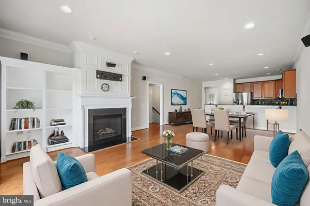 a view of a livingroom with a kitchen and a fireplace