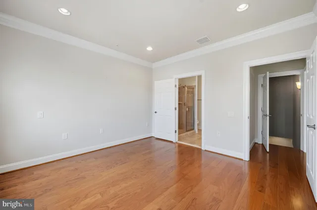 a view of hallway with wooden floor
