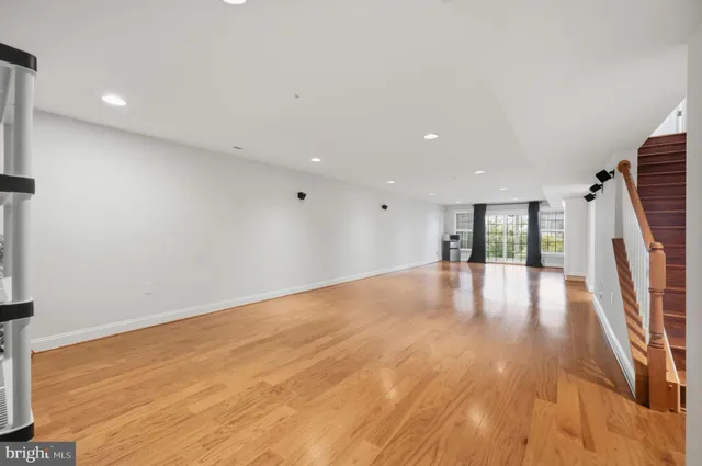 a view of empty room with wooden floor