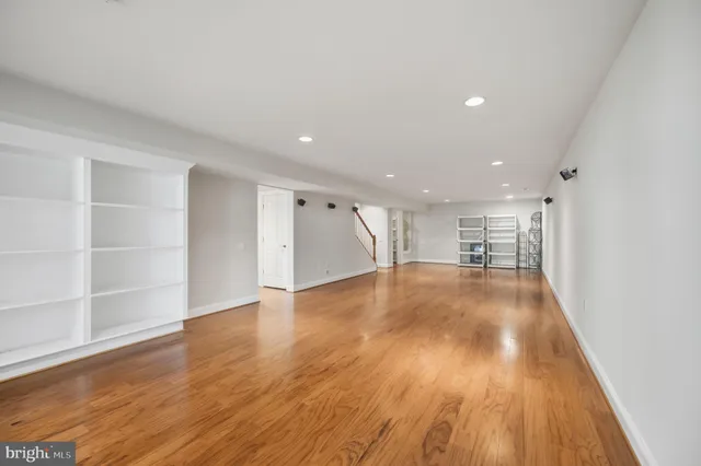 a view of an empty room with wooden floor