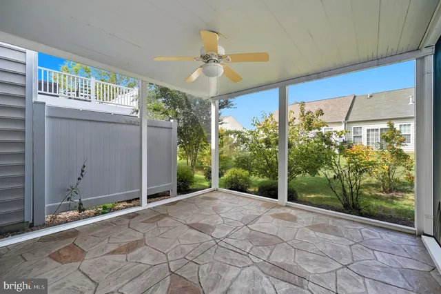 a view of a street with benches and trees