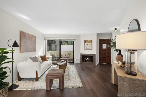 a living room with furniture a fireplace and a table