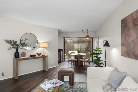 a living room with furniture flowerpot and wooden floor