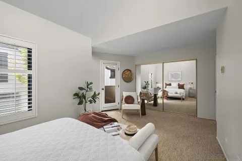 a bedroom with furniture and a large window