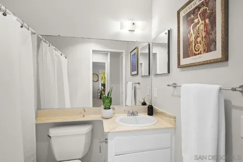 a bathroom with a sink a toilet and mirror