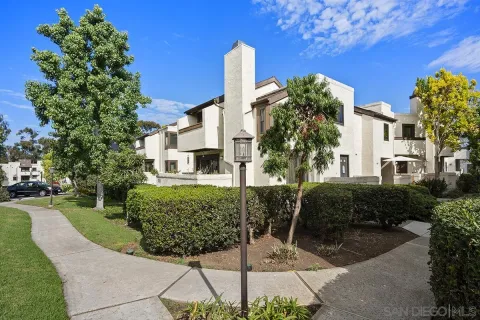 a view of a house with a yard and plants