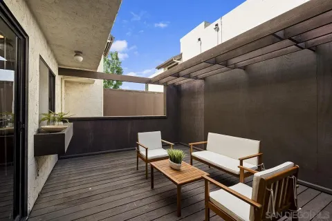 a view of balcony with wooden floor and outdoor seating