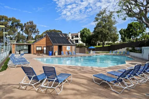 a swimming pool with outdoor seating and yard