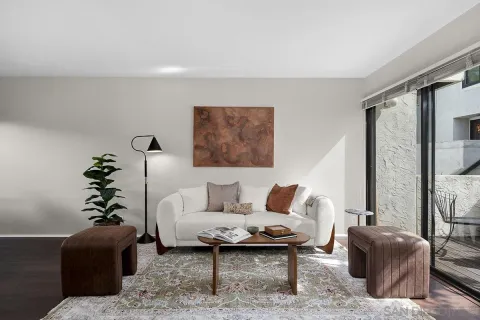 a living room with furniture a table and a potted plant