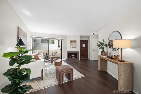 a living room with fireplace furniture and a wooden floor