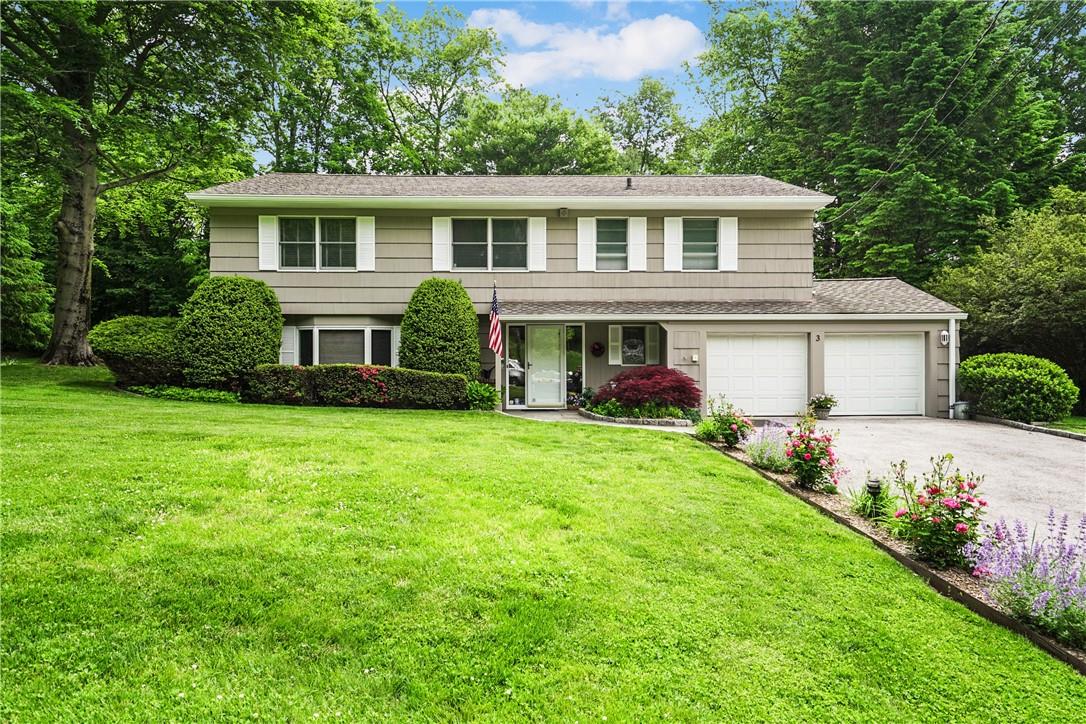 a front view of house with yard and green space