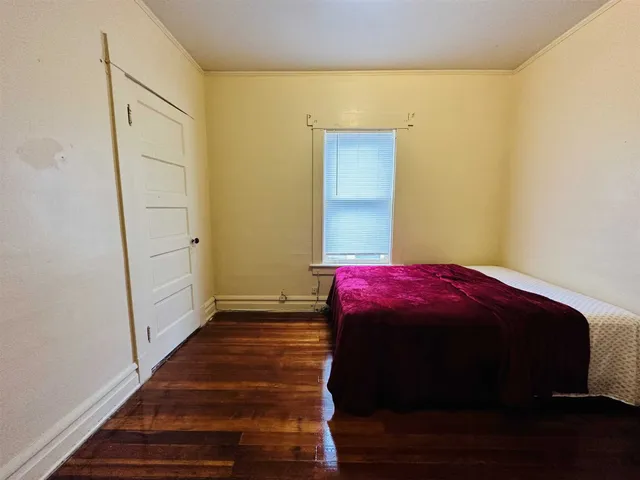 a bedroom with a bed and a mirror