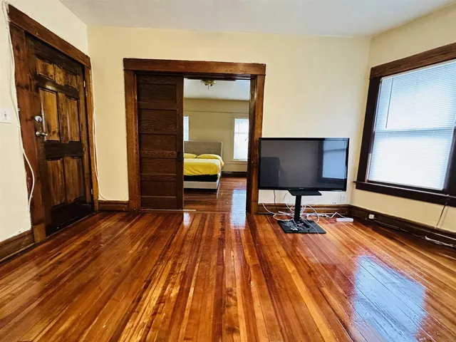 a view of a workspace with wooden floor and furniture