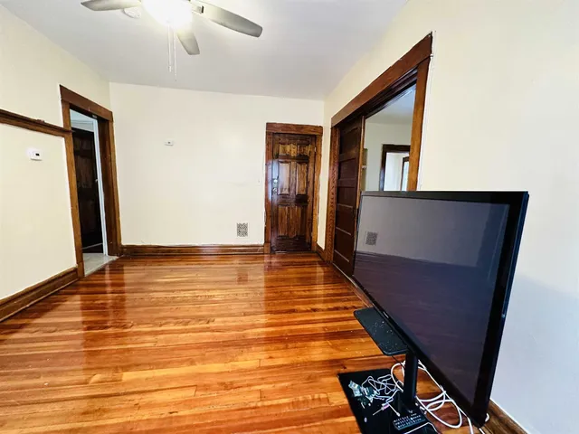 a view of room with window and wooden floor