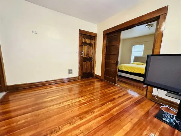 a view of room with wooden floor
