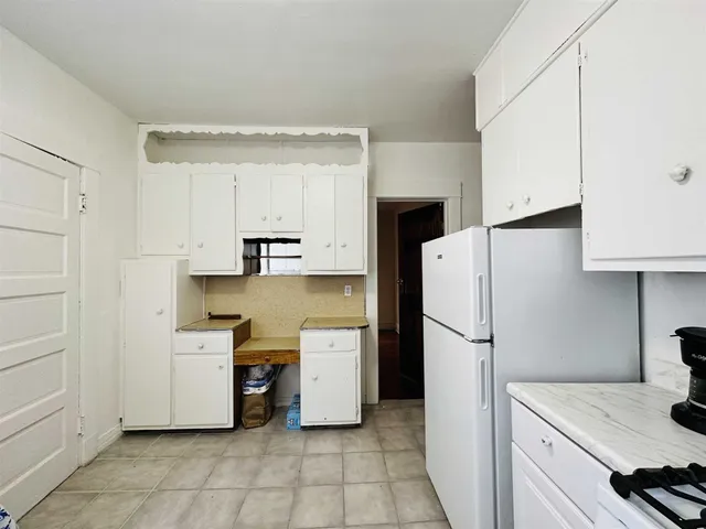 a kitchen with a refrigerator a stove and a sink