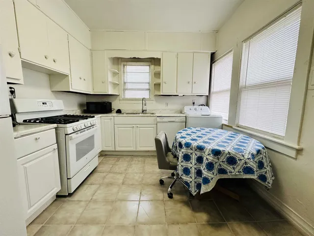 a kitchen with a stove a sink and a microwave