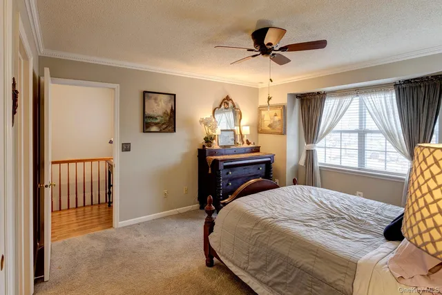 a bedroom with a bed and a ceiling fan